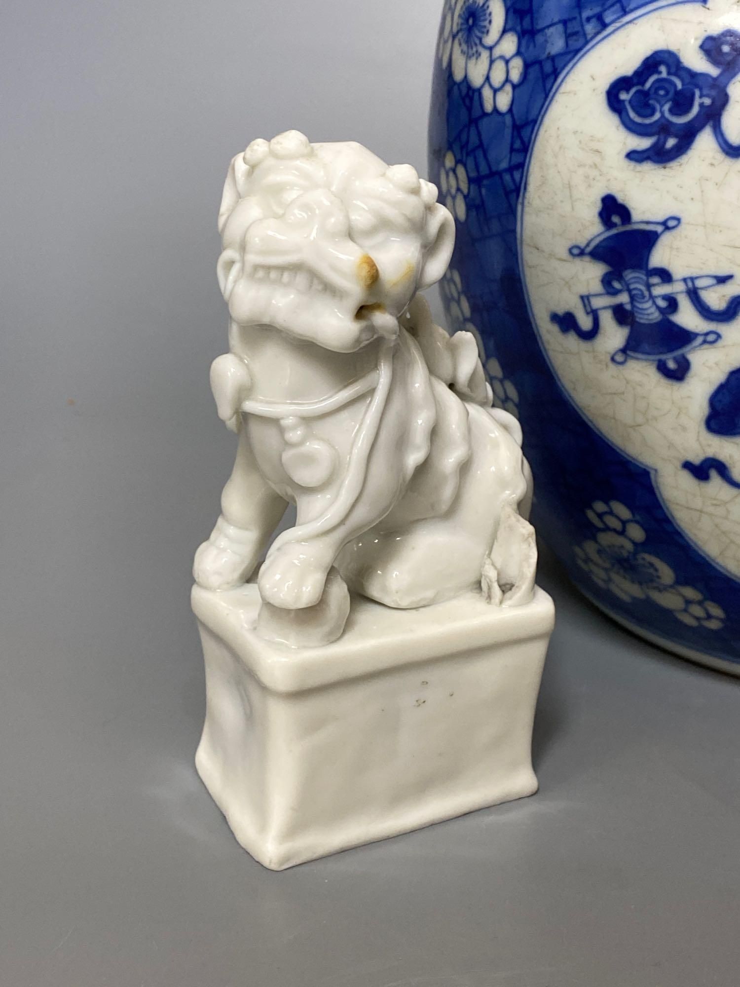 A Chinese blue and white ginger jar and cover, Kangxi period, 22.5cm and two blanc de chine dogs of fo